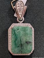 Front view showing emerald, halo and bail