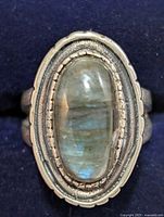 Top view showing oval labradorite cabochon and decorative silver frame