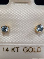 Front view of both blue zircon studs mounted on 14 KT. GOLD card