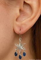 Earring worn to show scale and design