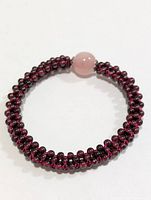 Full view of garnet bead bracelet with rose quartz focal bead