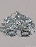 Group of loose light blue aquamarine gemstones assorted cuts