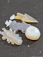 Group of four carved opal stones on dark background