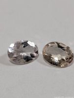 Close-up of both oval morganite gemstones showing color and faceting