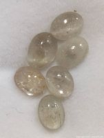 Six oval cabochon stones on white background