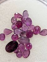 Close-up of loose rubies showing color, cut variety and clarity