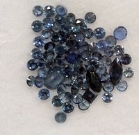 Loose faceted blue sapphires assorted cuts on white background