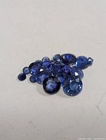 Group of loose blue sapphires on surface