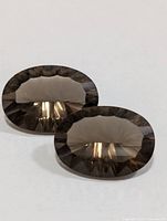 Two oval smokey quartz gemstones front view