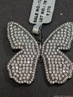 Front view of silver butterfly pendant fully set with white zircon stones