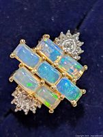 Front view of ring showing opal arrangement and accent stones