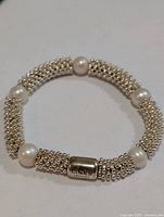Full bracelet showing silver bead segments and pearls