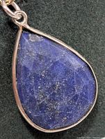 Front view of pear-shape lapis lazuli pendant in silver frame
