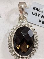 Front view of pendant showing faceted smoky quartz and rope bezel