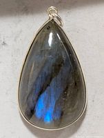 Front view of teardrop labradorite pendant showing blue flash and silver bezel