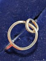 Front view of silver ring showing circular and loop design