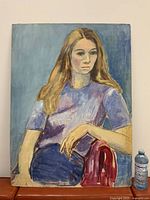 Full view of vertical oil portrait on board against wall with water bottle for scale