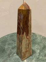 Front view of onyx obelisk showing colour bands and overall form
