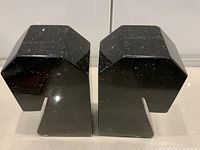 Front view of both black granite rook-shaped bookends