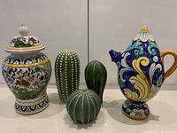 All five ceramic items grouped together showing designs and condition