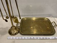 Tray beside fireplace tool set showing relative size and brass material