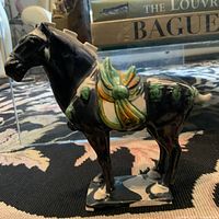 Left side view of sancai-glazed pottery horse statue on table