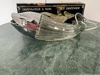 Side view of whale nut dispenser with original box behind