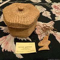 Large lidded basket, carved pendant necklace and business card
