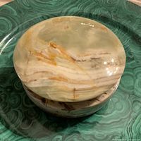 Top view of round onyx trinket box lid showing banded stone