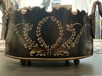 Front view showing hand-painted laurel motif and scalloped rim