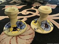 Both candleholders showing overall design and condition