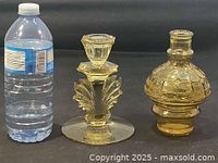 Group view showing water bottle for scale, vase, and candle holder