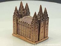 Front angled view showing façade, spires, and base