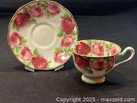 Teacup and saucer front view showing pattern and gold trim