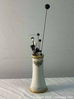 Full view porcelain hatpin holder filled with hatpins