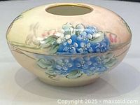 Oblique view of Limoges hair receiver showing floral decoration and opening