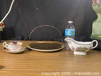 Group shot showing gravy boat, teacup, saucer and handled tray for scale