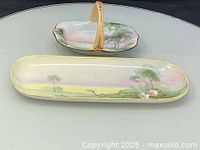 Oblong tray and handled dish showing painted scenes and gold trim