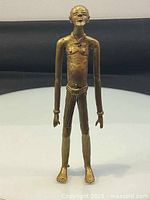 Front view of brass figurine