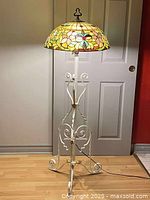 Full view of floor lamp showing base, pole and shade