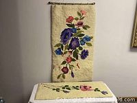 Both wall hangings, large piece hung, smaller piece flat