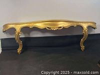 Front view of ornate gilt wood wall shelf