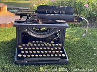 Front view showing full typewriter, brand marking, carriage and keys