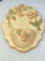 Front view of scalloped wall vase showing relief flowers and bird