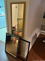 Full-length mirror, floral mirror, empty frame stacked against wall