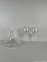 Front view showing clear glass decanter and two etched wine glasses