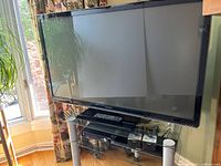 Front view of Panasonic 50-inch TV on glass stand