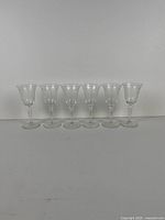 group shot of six etched stemmed wine glasses