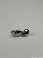 Pair of cufflinks angled view showing faceted design and bullet backs