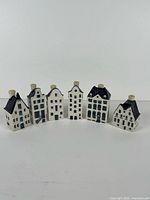 Front view of six KLM Delft Blue house miniatures